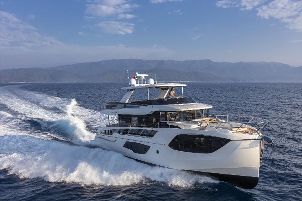 Slide: The Image of 2024 Absolute Navetta 64 yacht cruising on open water. - 0