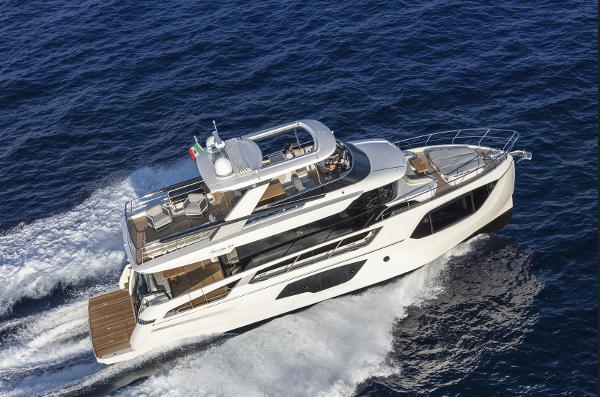 Slide: The Image of 2024 Absolute Navetta 64 luxury yacht cruising on open water. - 2