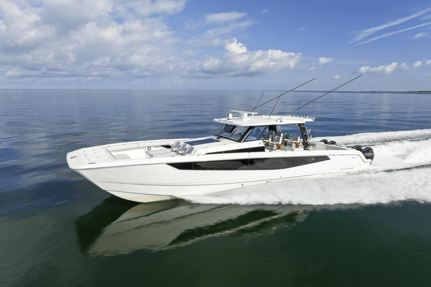 Slide: The Image of 2024 Aquila 47 Molokai cruising on calm waters under a blue sky. - 0