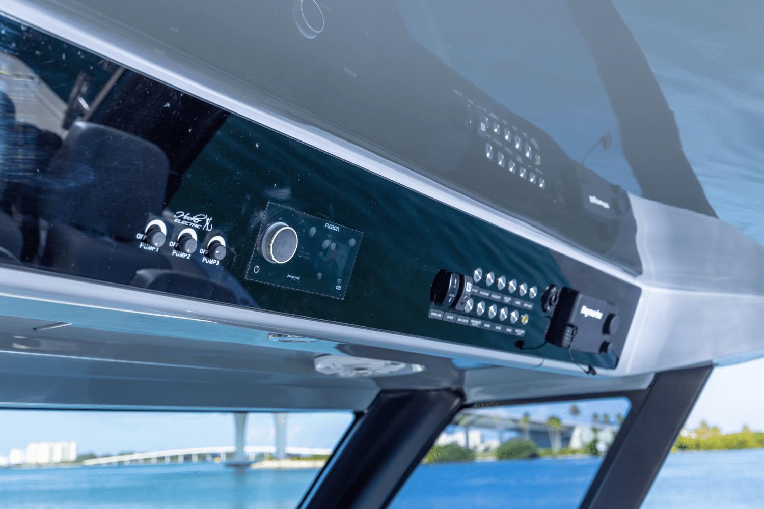 Slide: The Image of Control panel of 2024 Aquila 47 Molokai boat with water view in background. - 18