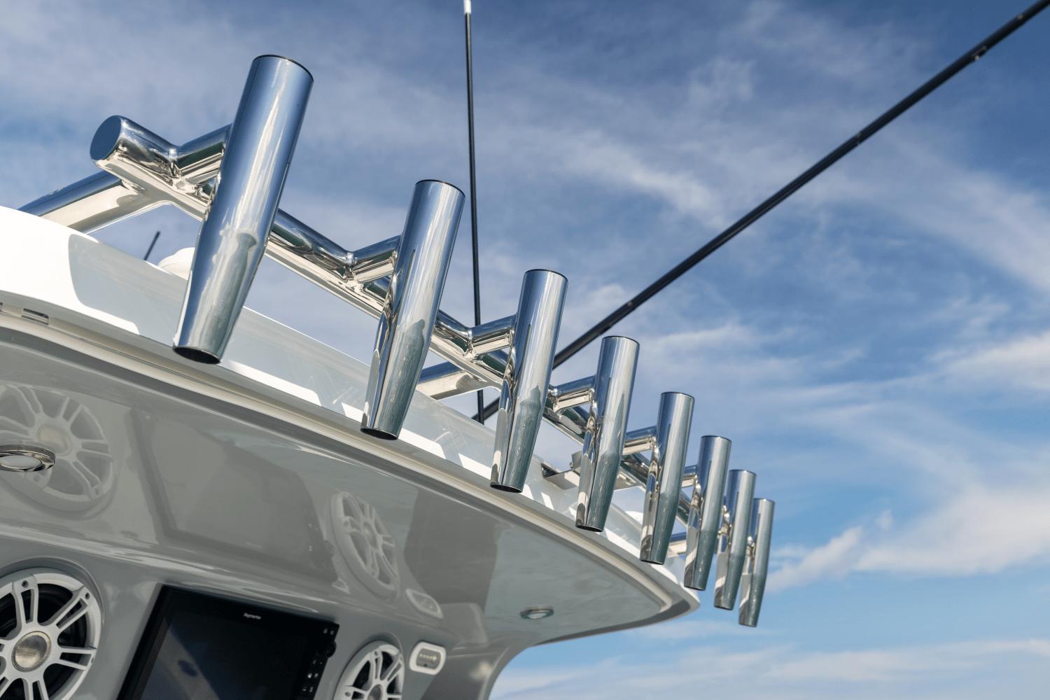 Slide: The Image of Rod holders on the 2024 Aquila 47 Molokai boat against a blue sky. - 5