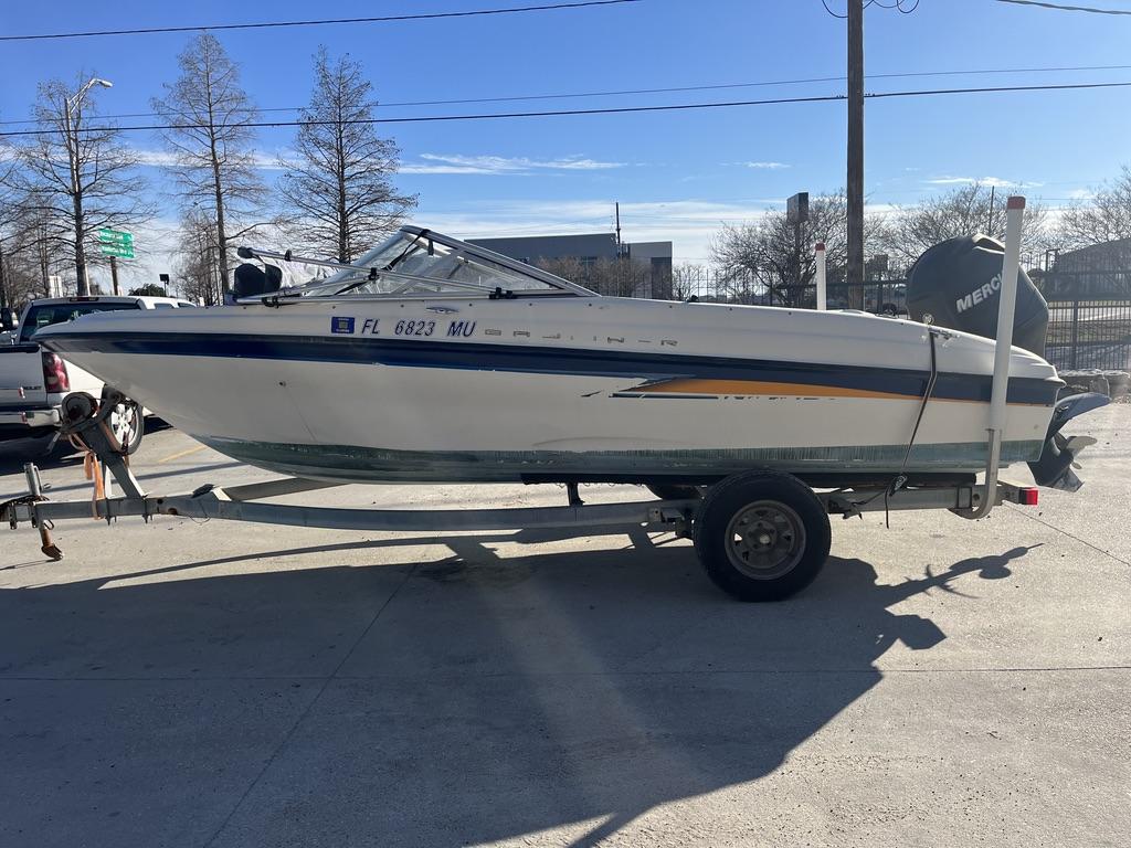 Slide: The Image of 2004 Bayliner 175 boat on trailer, parked outdoors under clear blue sky. - 11