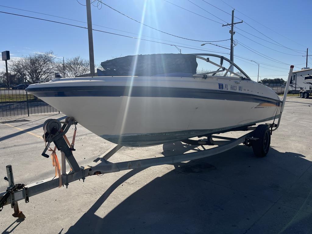 Slide: The Image of 2004 Bayliner 175 boat on trailer in sunny outdoor setting. - 12
