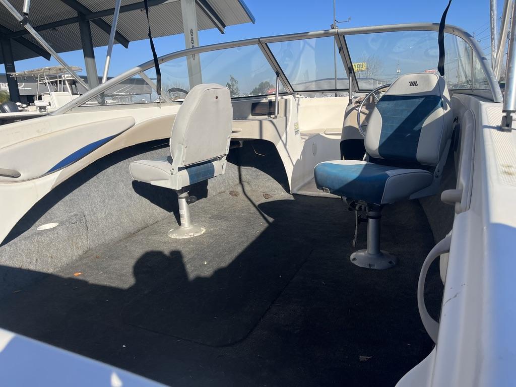 Slide: The Image of 2004 Bayliner 175 boat interior with two seats and windshield under a canopy. - 3