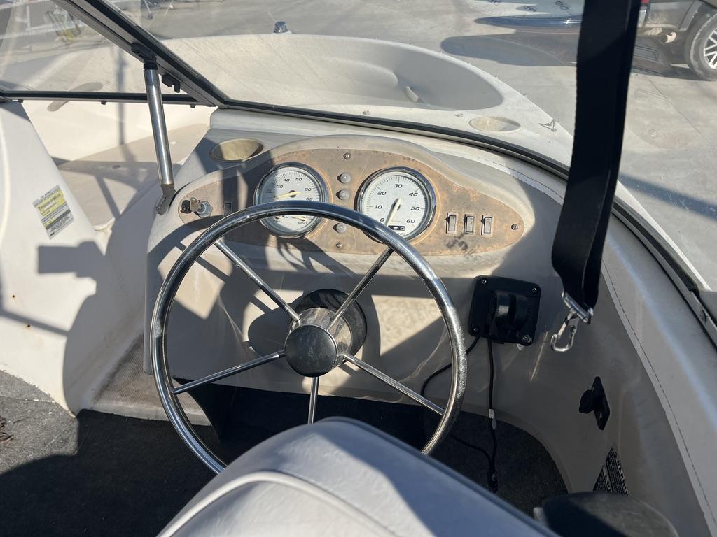 Slide: The Image of 2004 Bayliner 175 boat dashboard with steering wheel and gauges. - 8