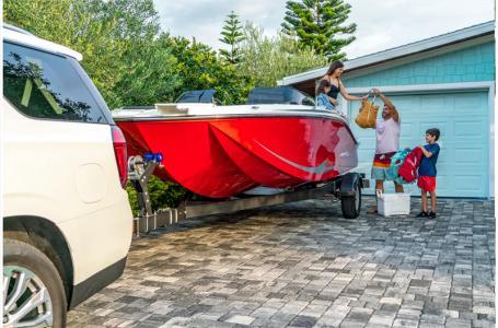 Slide: The Image of Family preparing 2024 Bayliner Element M19 boat for a trip in driveway. - 7