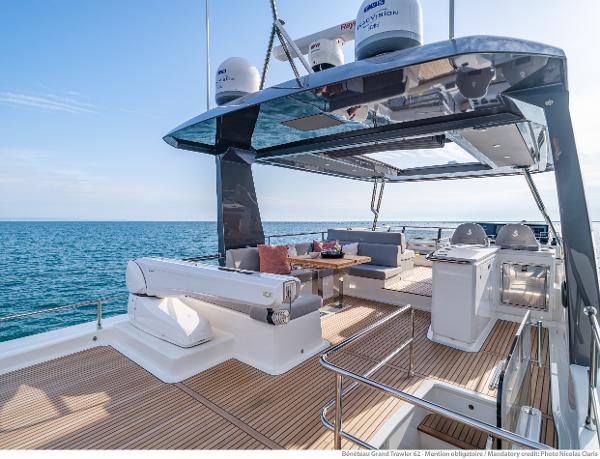 Slide: The Image of Luxurious 2025 Beneteau Grand Trawler 62 yacht deck with seating and ocean view. - 11