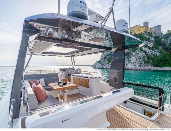 Slide: The Image of Luxurious 2025 Beneteau Grand Trawler 62 yacht with elegant outdoor seating and scenic ocean view. - 12