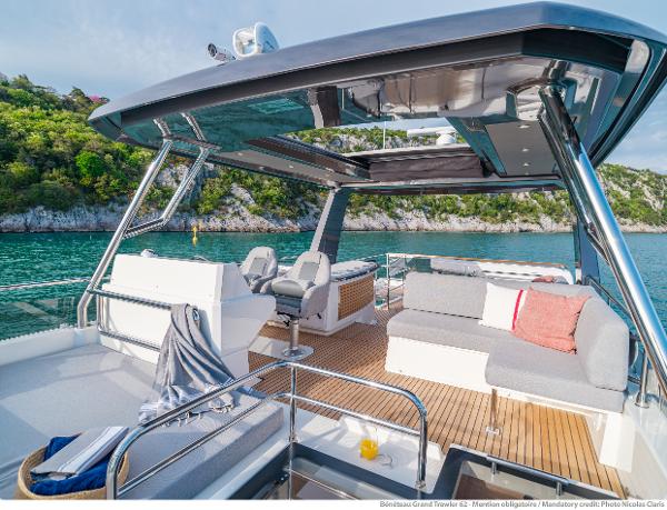 Slide: The Image of Luxurious 2025 Beneteau Grand Trawler 62 yacht with spacious deck and scenic water view. - 13