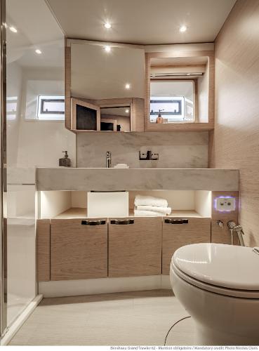 Slide: The Image of Luxurious bathroom in 2025 Beneteau Grand Trawler 62 yacht, featuring modern fixtures and elegant design. - 34