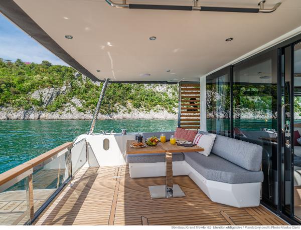 Slide: The Image of Luxurious 2025 Beneteau Grand Trawler 62 yacht deck with scenic water view. - 7