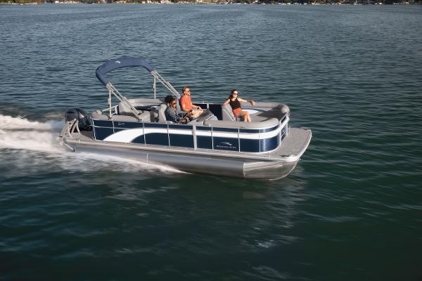 Slide: The Image of 2023 Bennington 22SSR pontoon boat cruising on a lake with passengers. - 11