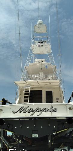 Slide: The Image of Alt text: 2005 Bertram 570 yacht named Moppie with a tall tower, docked under a blue sky. - 3