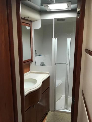 Slide: The Image of 2005 Bertram 570 yacht bathroom with shower and vanity. - 8
