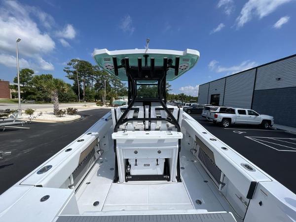 Slide: The Image of 2024 Blackfin 272 CC center console boat with T-top in a parking lot. - 5