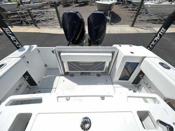 Slide: The Image of 2024 Blackfin 272 CC boat stern with twin outboard engines. - 7