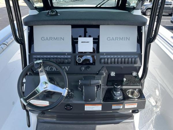 Slide: The Image of 2024 Blackfin 272 CC boat dashboard with Garmin displays and Mercury controls. - 9