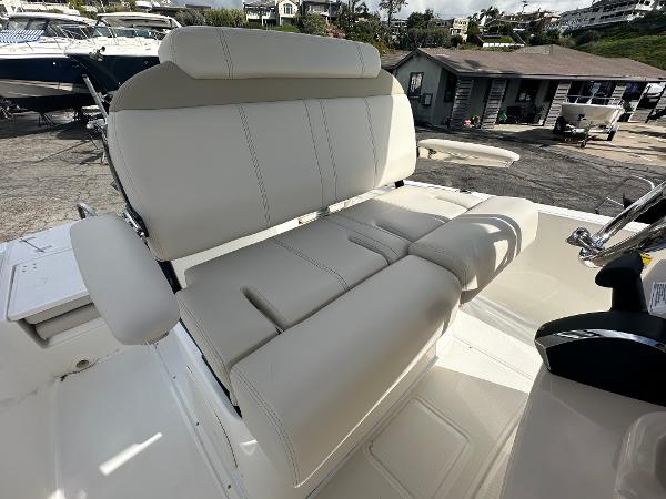Slide: The Image of 2024 Boston Whaler 220 Dauntless boat seating area with white upholstery. - 7