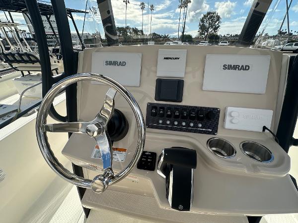 Slide: The Image of Control console of 2024 Boston Whaler 220 Dauntless with Simrad electronics and Mercury throttle. - 8