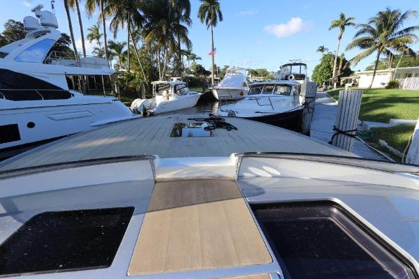 Slide: The Image of 2018 Canados Gladiator 428 docked with other luxury yachts, surrounded by palm trees. - 13