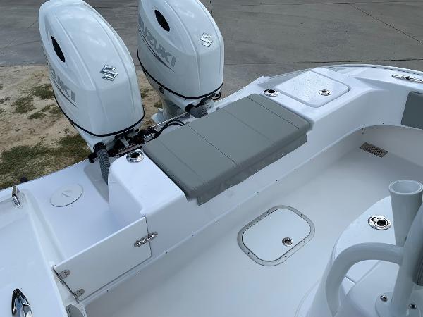 Slide: The Image of 2024 Cape Horn 24 XS boat with dual Suzuki outboard engines and cushioned seating. - 20