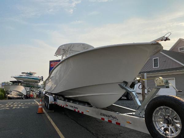 Slide: The Image of 2024 Cape Horn 34 XS boat on trailer in marina. - 0