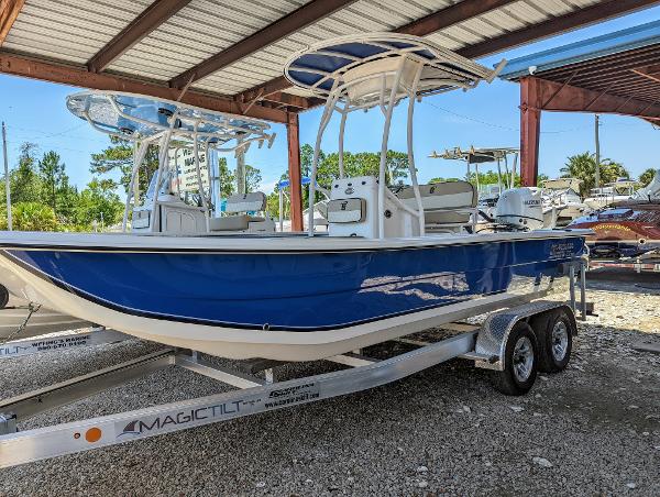 Slide: The Image of 2022 Carolina Skiff 21 SWS boat on Magic Tilt trailer under a metal canopy. - 0