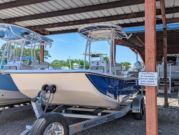 Slide: The Image of 2022 Carolina Skiff 21 SWS boat on a trailer under a covered area. - 1