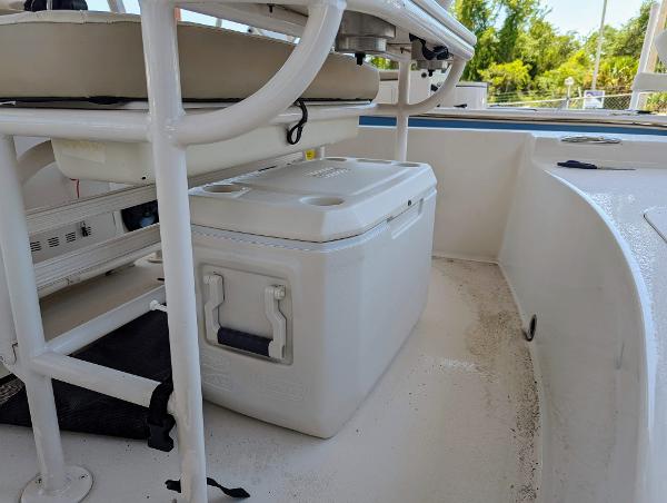 Slide: The Image of 2022 Carolina Skiff 21 SWS boat interior with cooler and seating. - 11