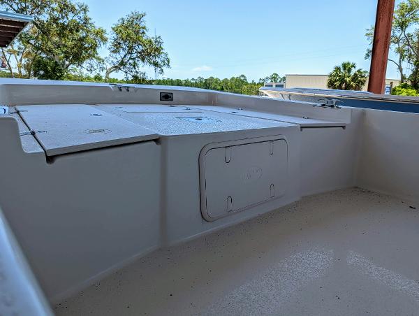 Slide: The Image of 2022 Carolina Skiff 21 SWS boat interior, spacious deck with storage compartments. - 12