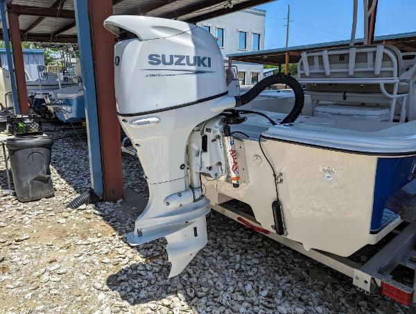 Slide: The Image of 2022 Carolina Skiff 21 SWS with Suzuki outboard motor in a boatyard. - 4