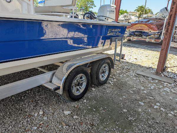 Slide: The Image of 2022 Carolina Skiff 21 SWS boat on a dual-axle trailer in a boatyard. - 5