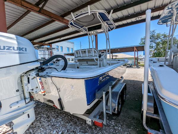 Slide: The Image of 2022 Carolina Skiff 21 SWS boat on trailer under a metal canopy. - 6