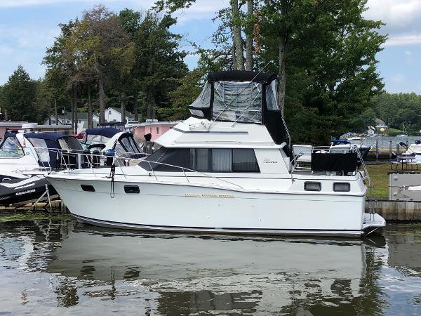 Slide: The Image of 1983 Carver 32 Aft Cabin boat docked at a marina. - 0