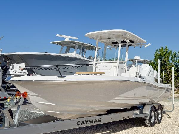 Slide: The Image of 2024 Caymas 28 HB boat on trailer under clear blue sky. - 1