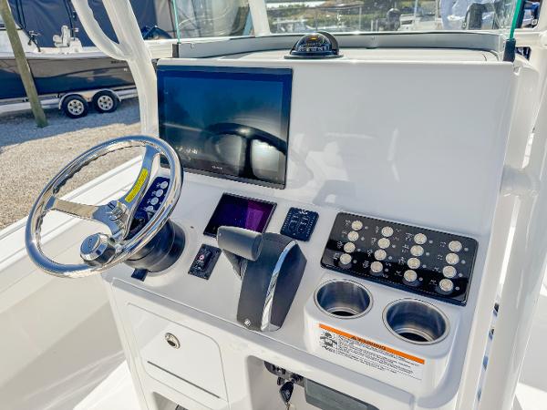 Slide: The Image of 2024 Caymas 28 HB boat console with steering wheel and control panel. - 16
