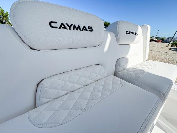 Slide: The Image of 2024 Caymas 28 HB boat with luxurious white seating and embroidered logo. - 18
