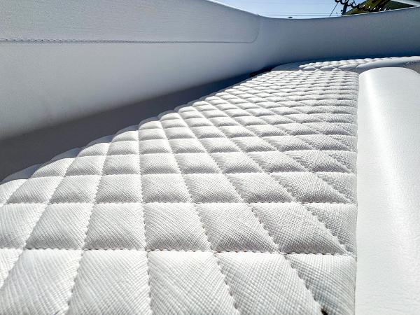 Slide: The Image of 2024 Caymas 28 HB boat interior with quilted upholstery detail. - 24