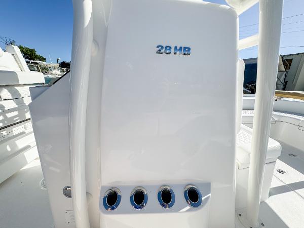 Slide: The Image of 2024 Caymas 28 HB boat interior with sleek white design and rod holders. - 29