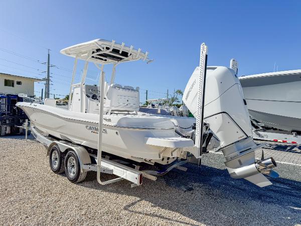 Slide: The Image of 2024 Caymas 28 HB boat on trailer, featuring powerful outboard motor. - 3