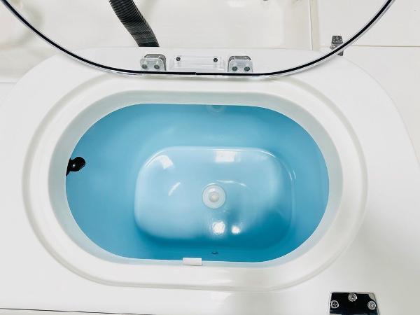 Slide: The Image of 2024 Cobia 262 CC livewell with blue interior and open lid. - 10