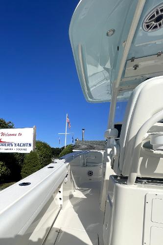Slide: The Image of 2024 Cobia 262cc boat at Modern Yachts dealership under clear blue sky. - 12