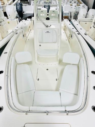 Slide: The Image of 2024 Cobia 262 CC boat interior with white seating and console. - 13