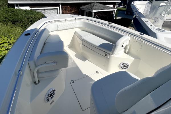 Slide: The Image of 2024 Cobia 262cc boat interior with cushioned seating and built-in speakers. - 13