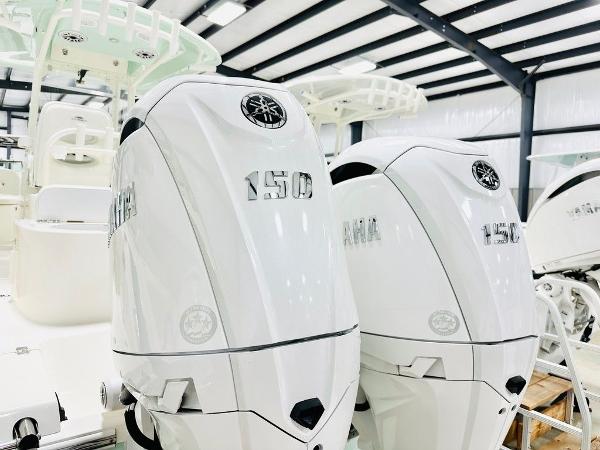 Slide: The Image of 2024 Cobia 262 CC with twin Yamaha 150 engines in a showroom. - 14