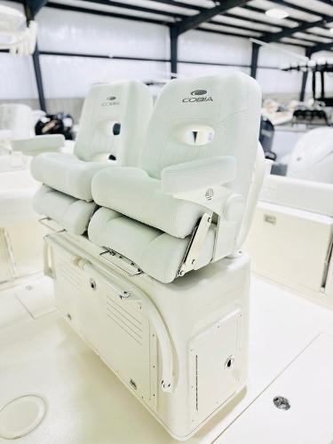 Slide: The Image of 2024 Cobia 262 CC boat seats in a showroom. - 16