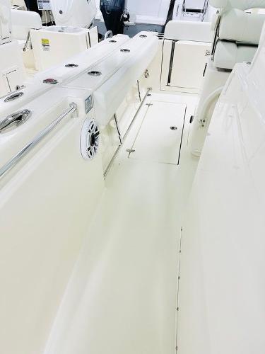 Slide: The Image of 2024 Cobia 262 CC boat interior with seating and storage compartments. - 17