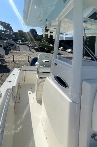 Slide: The Image of 2024 Cobia 262cc boat, side view of deck and seating area. - 17