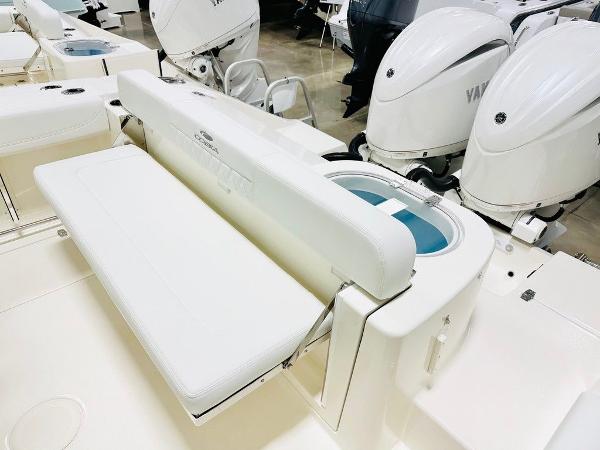 Slide: The Image of 2024 Cobia 262 CC boat with Yamaha engines and white seating. - 2