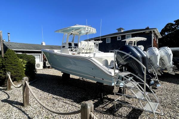 Slide: The Image of 2024 Cobia 262cc boat on display with dual outboard engines. - 2